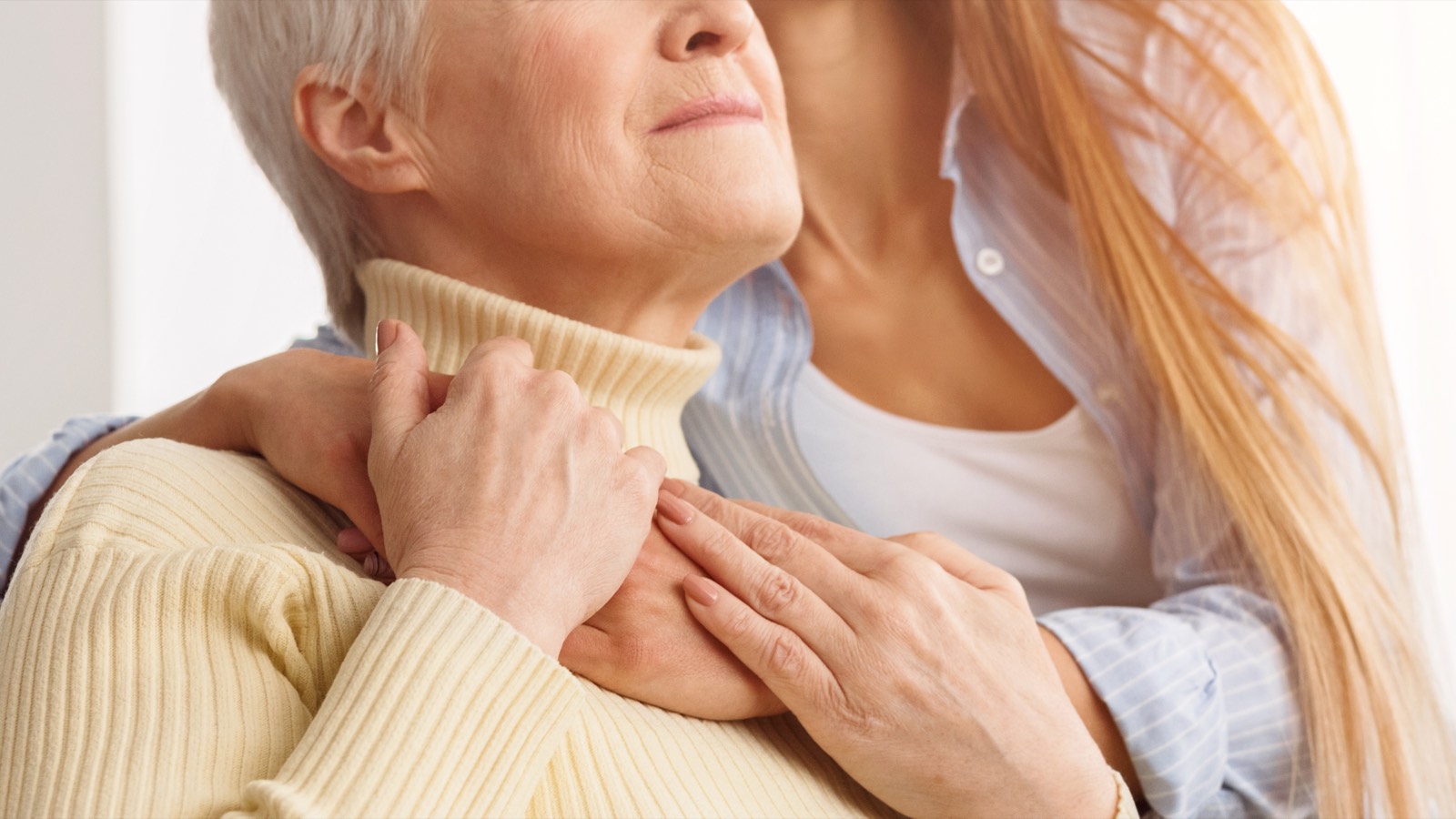 A daughter embraces her mother in a moment of quiet support